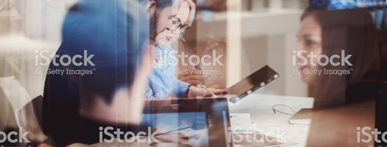 People having discussion over computers and notebooks